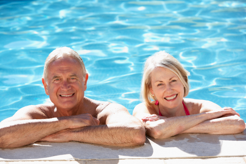 Senior Couple Relaxing In Swimming Poo