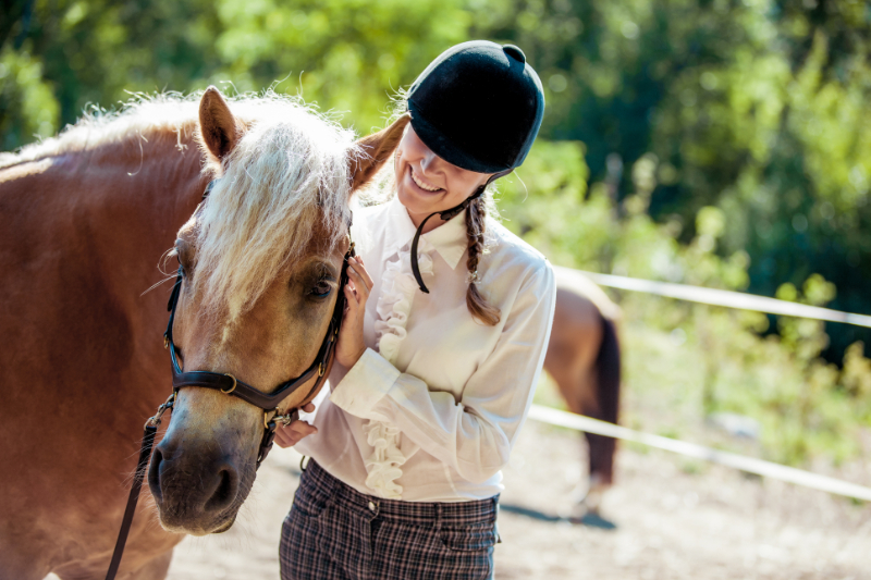 woman looking on the horse smiling