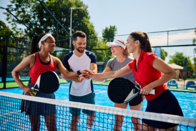 Group of Friends Playing Paddle Tennis at The Isles at Wellington Clubhouse