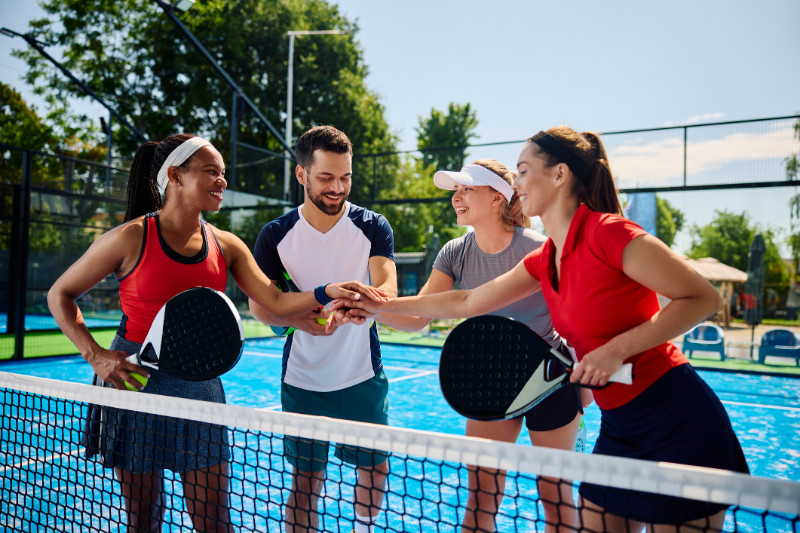 Group of Friends Playing Paddle Tennis at The Isles at Wellington Clubhouse